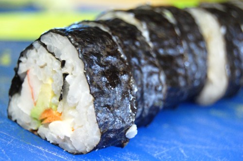 Sushi roll on blue cutting board