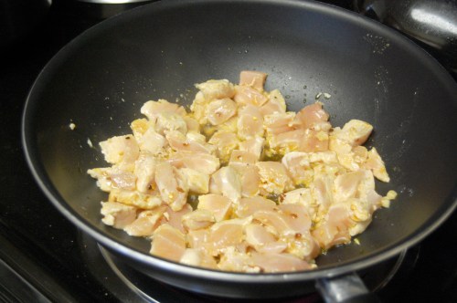 Sautéing chicken in the pan with spices and oil