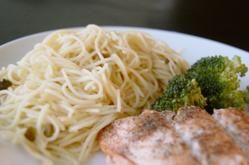 White wine lemon butter pasta with capers, beside salmon and broccoli